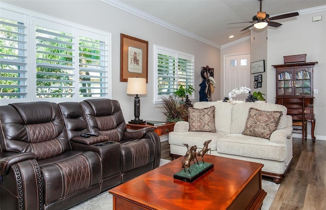 living room featuring lofted ceiling, hardwood / wood-style flooring, ornamental molding, and ceiling fan