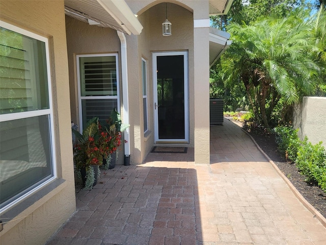 201 Auburn Woods Cir, Venice, FL 34292 - doorway to property featuring stucco siding and a patio