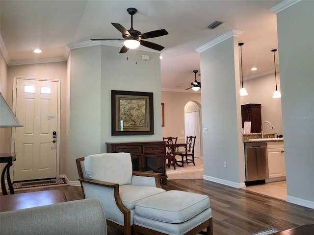 201 Auburn Woods Cir, Venice, FL 34292 - living area with a ceiling fan, crown molding, light wood-style floors, arched walkways, and recessed lighting