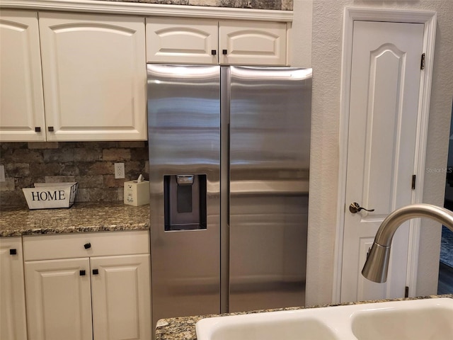 201 Auburn Woods Cir, Venice, FL 34292 - kitchen featuring stainless steel fridge, tasteful backsplash, white cabinetry, and dark stone countertops