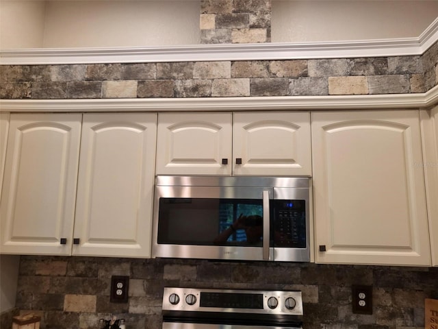 201 Auburn Woods Cir, Venice, FL 34292 - kitchen view of stainless steel microwave, white cabinets, and tasteful backsplash