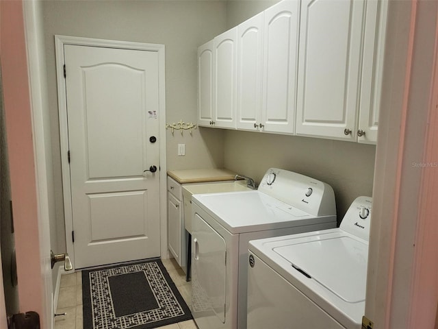 201 Auburn Woods Cir, Venice, FL 34292 - laundry room with cabinet space, washer and clothes dryer, and light tile patterned floors