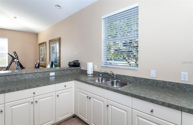 201 Auburn Woods Cir, Venice, FL 34292 - kitchen with white cabinets and dark countertops
