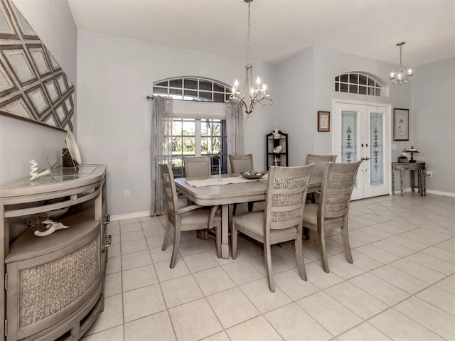 tiled dining room featuring french doors and an inviting chandelier