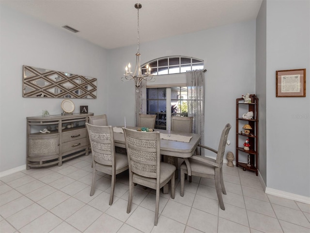 tiled dining room with a notable chandelier