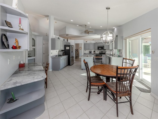 dining space featuring ceiling fan, sink, and light tile patterned floors