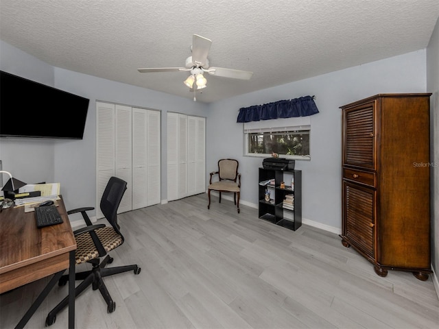 office area featuring ceiling fan, a textured ceiling, and light hardwood / wood-style flooring