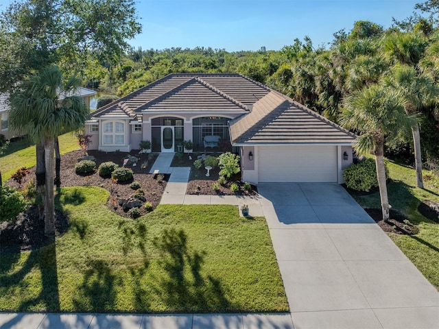 single story home featuring a porch, a garage, and a front lawn