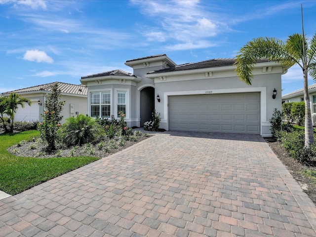 mediterranean / spanish-style house with a garage