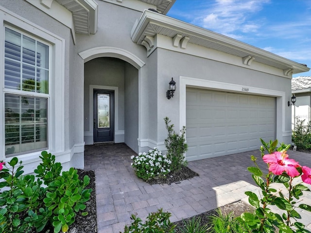 view of exterior entry with a garage