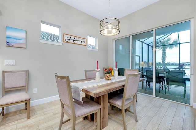 dining room with a chandelier and light hardwood / wood-style flooring