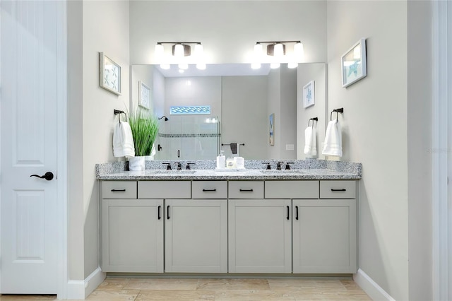 bathroom featuring wood-type flooring, a shower with door, and vanity