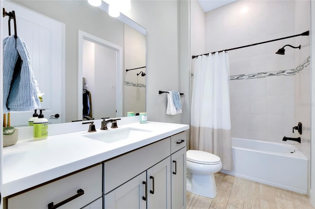 full bathroom featuring hardwood / wood-style floors, toilet, vanity, and shower / tub combo with curtain