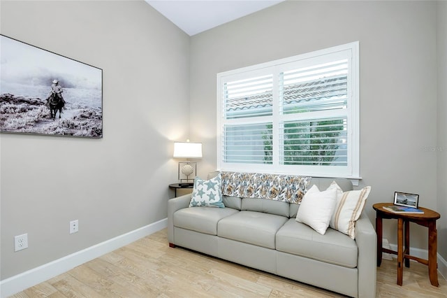 living room featuring plenty of natural light and light hardwood / wood-style floors