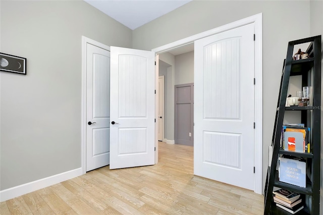 bedroom with a closet and light wood-type flooring