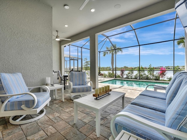 view of patio with an outdoor hangout area, ceiling fan, and glass enclosure