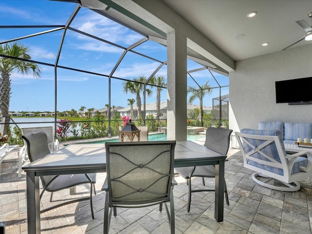 view of patio with a water view and glass enclosure