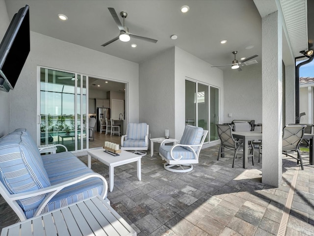 view of patio / terrace with ceiling fan and an outdoor living space