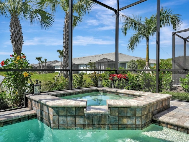 view of swimming pool with glass enclosure and an in ground hot tub