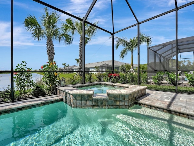 view of pool with a lanai and an in ground hot tub