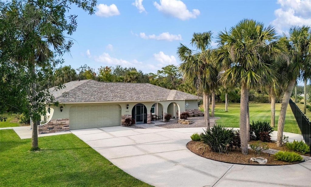 view of front of property with a garage and a front yard