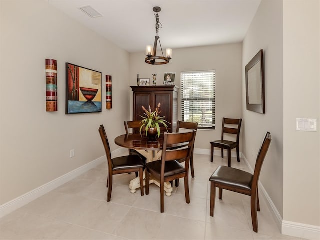 dining room featuring a notable chandelier and light tile patterned floors