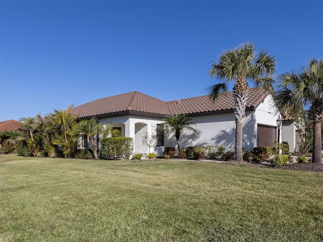 mediterranean / spanish home with a front yard