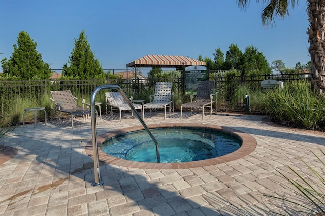 view of pool with a gazebo, a patio area, and a hot tub