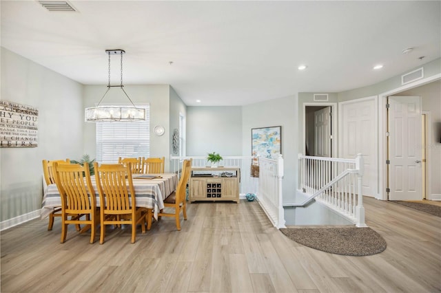 dining area featuring a chandelier and light hardwood / wood-style flooring