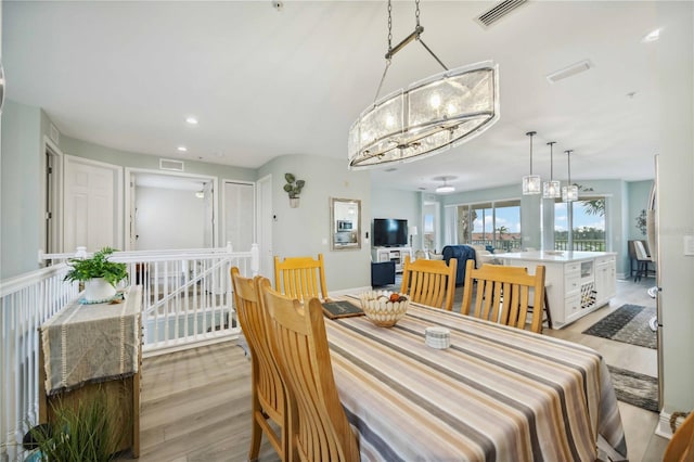 dining space with light hardwood / wood-style floors