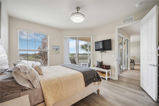 bedroom featuring light wood-type flooring and access to outside