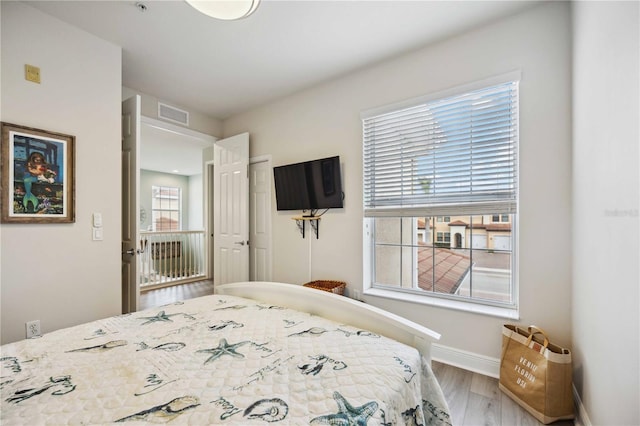 bedroom with hardwood / wood-style flooring