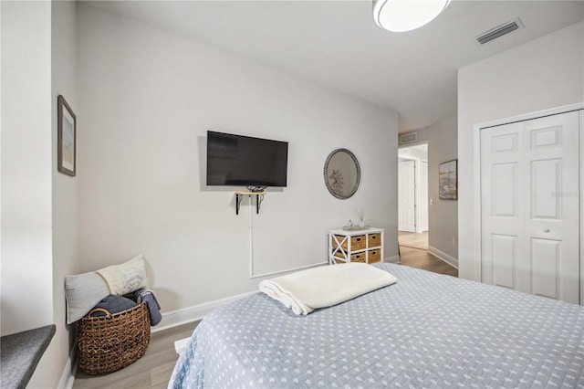 bedroom with a closet and light wood-type flooring