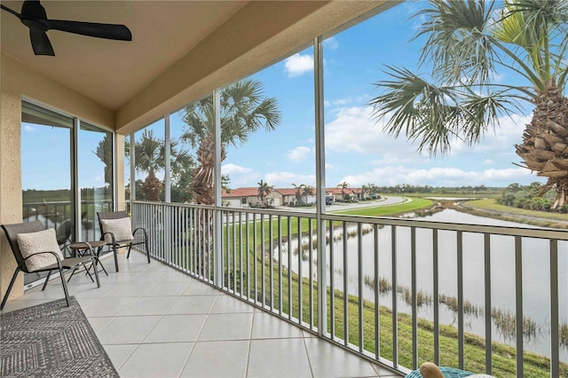 balcony with a water view and ceiling fan