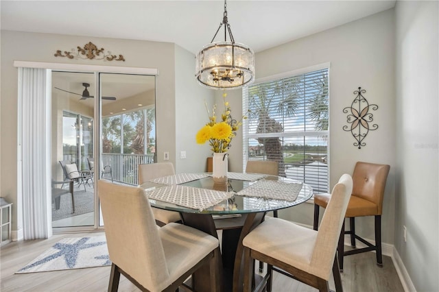 dining area with a notable chandelier and light wood-type flooring