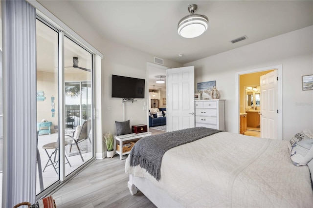 bedroom with access to exterior, light hardwood / wood-style floors, and ensuite bathroom