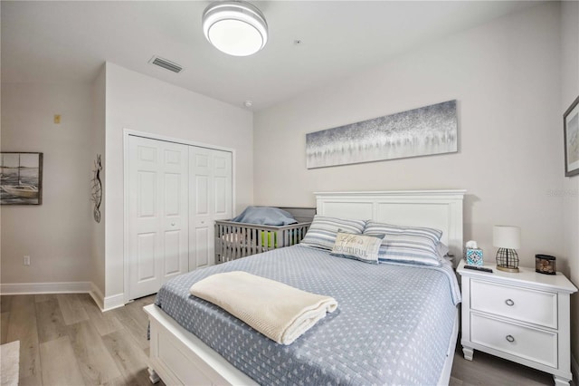 bedroom featuring light hardwood / wood-style flooring and a closet