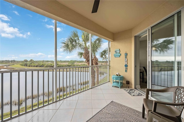 balcony with a water view and ceiling fan