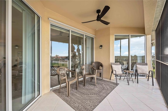 sunroom with plenty of natural light and ceiling fan