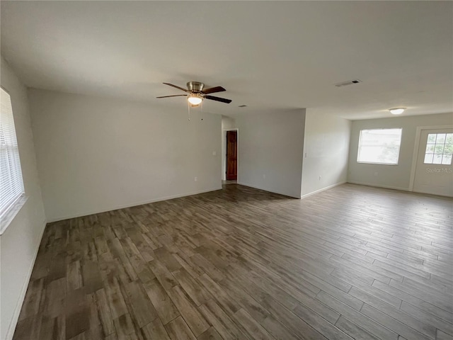 empty room with hardwood / wood-style floors and ceiling fan