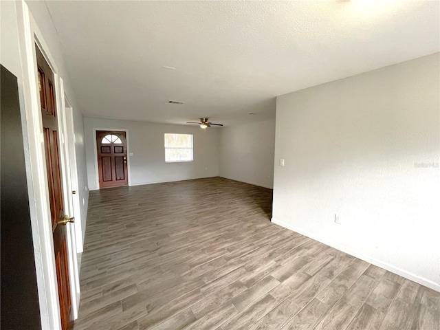 empty room featuring ceiling fan and light hardwood / wood-style floors