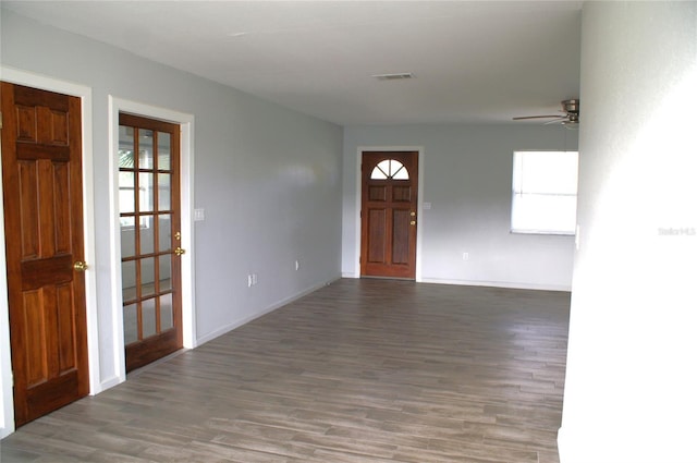 foyer with dark hardwood / wood-style floors and ceiling fan