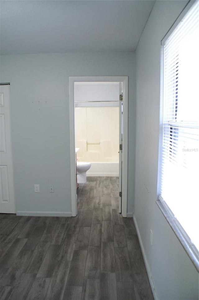 hallway with dark hardwood / wood-style floors