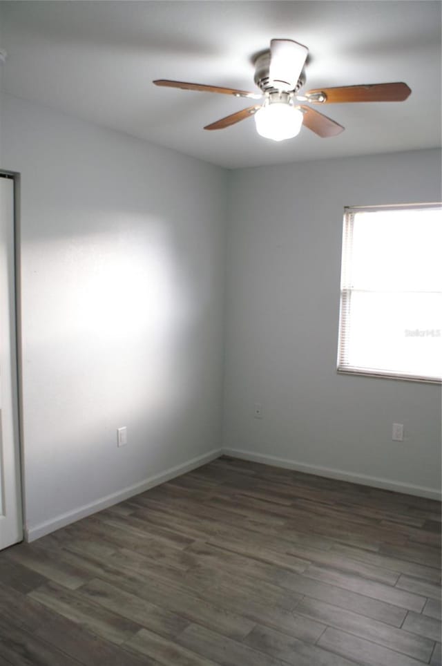 empty room featuring ceiling fan and dark hardwood / wood-style floors