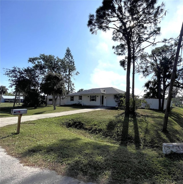 view of front of property with a front lawn and a garage