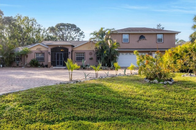 view of front of house with a garage and a front yard