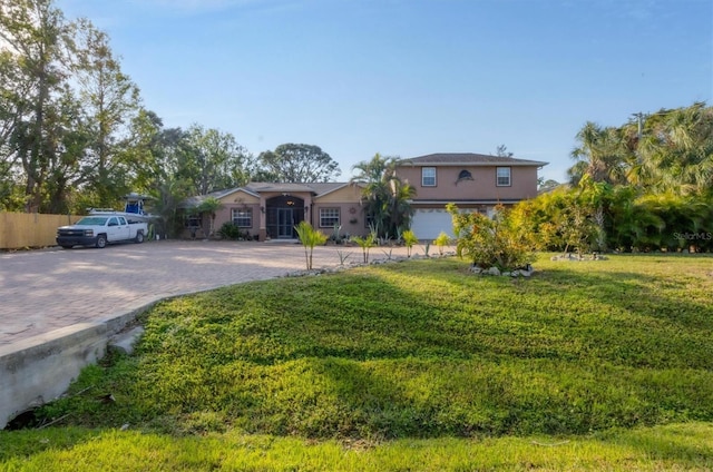 view of front of property with a front lawn and a garage