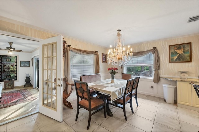 tiled dining space featuring an inviting chandelier, ornamental molding, and french doors