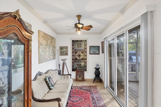 living area featuring ceiling fan and crown molding