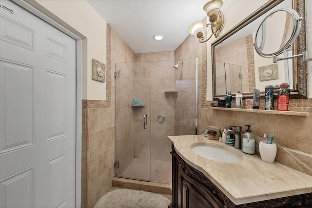 bathroom featuring vanity and a shower with door